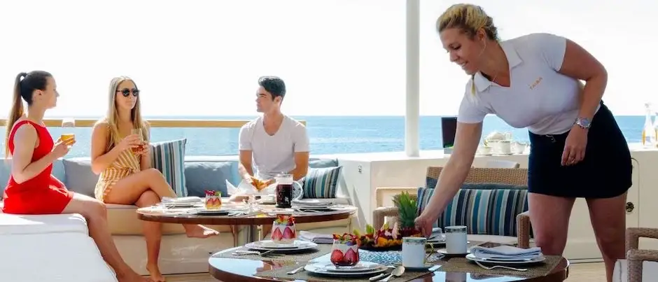 Stewardess preparing breackfast on a yacht