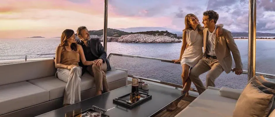 Two couples enjoying sunset on a yacht
