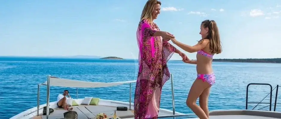 Mother and kid dancing on yacht