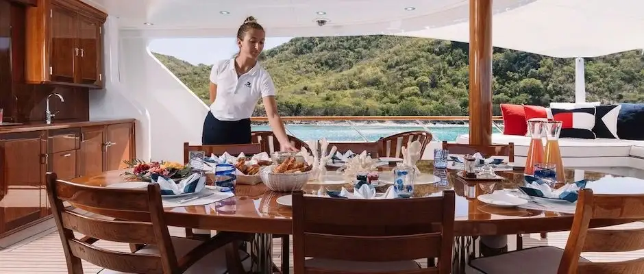 Stewardess preparing breackfast on a yacht