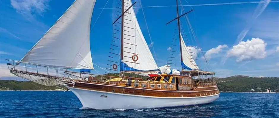 The typical design of a gulet is a two-or three-masted wooden sailing yacht with a motor